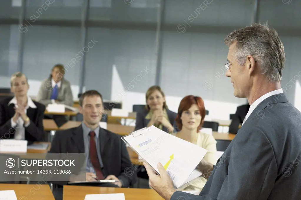 Businesspeople being lectured