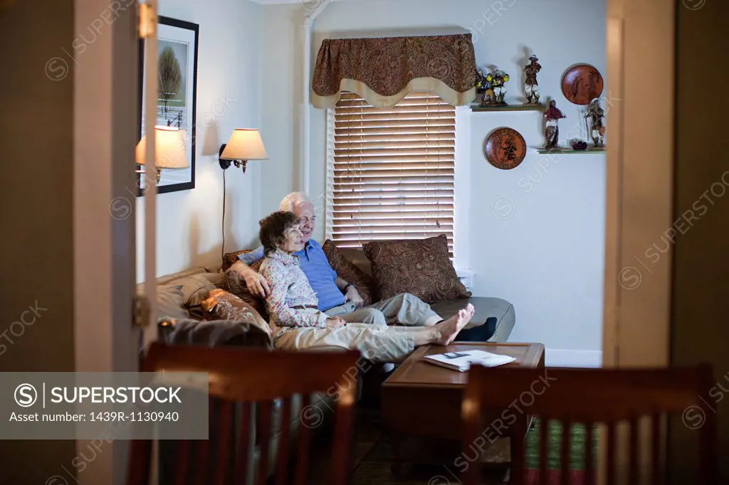 Senior couple watching tv at home