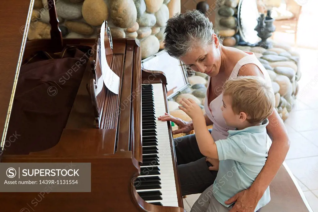 Grandmother and grandson playing the piano