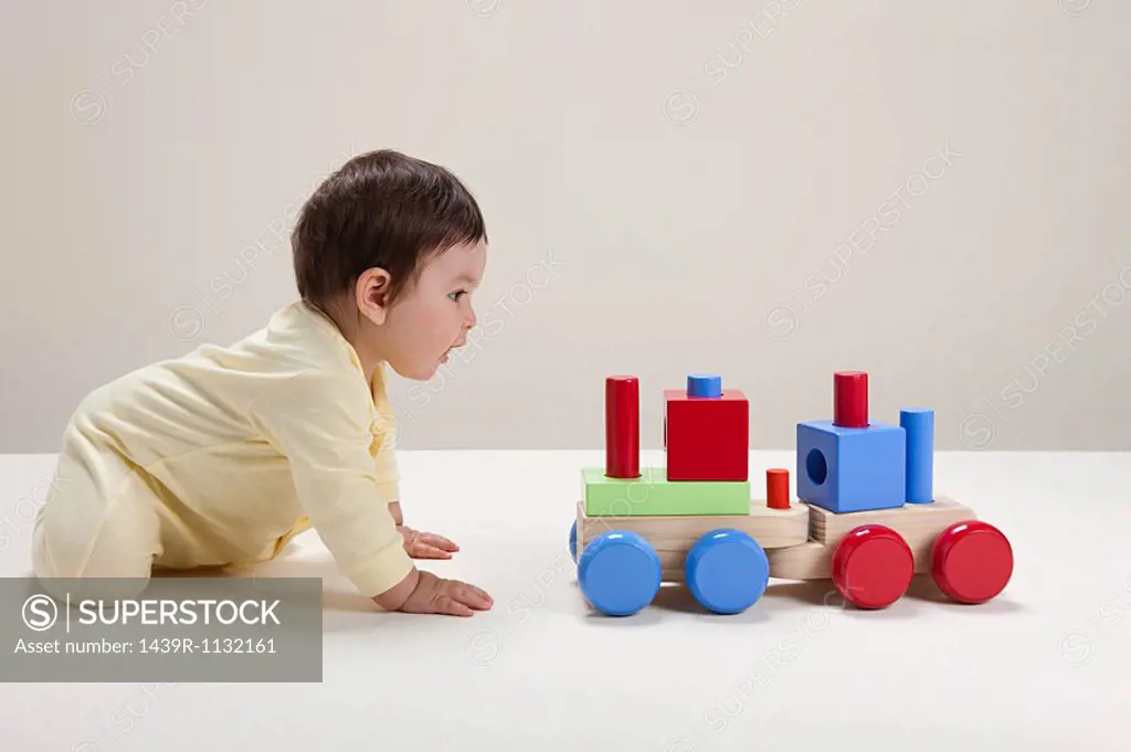 Baby boy playing with toy train