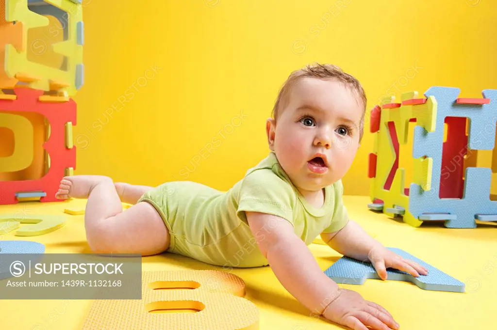 Baby boy playing with toy alphabet letters