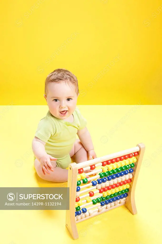 Baby boy playing with abacus