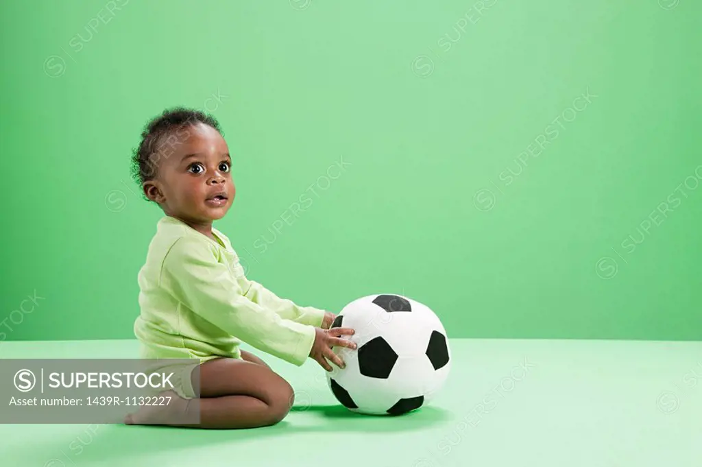 Baby boy playing with football