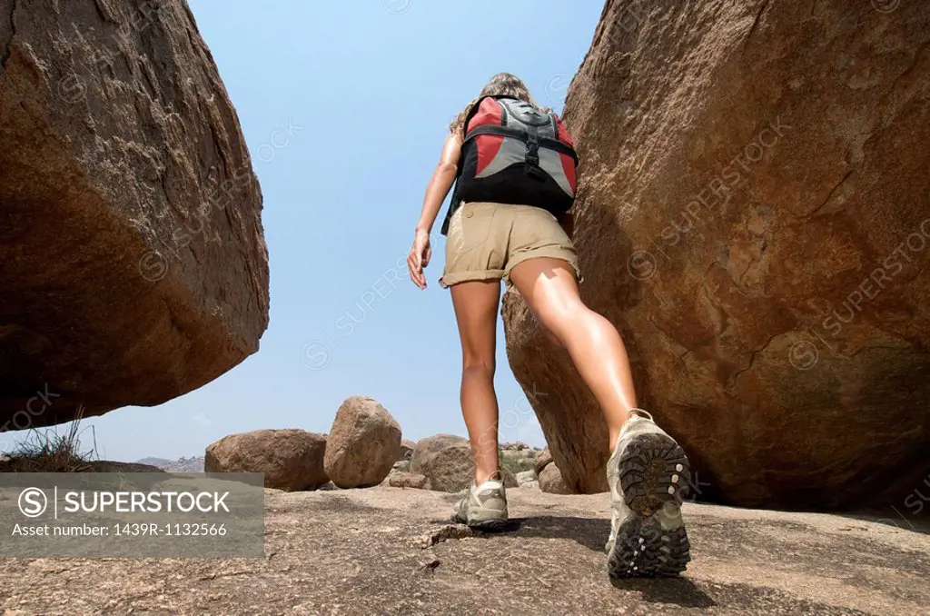 Woman hiking in rocky terrain