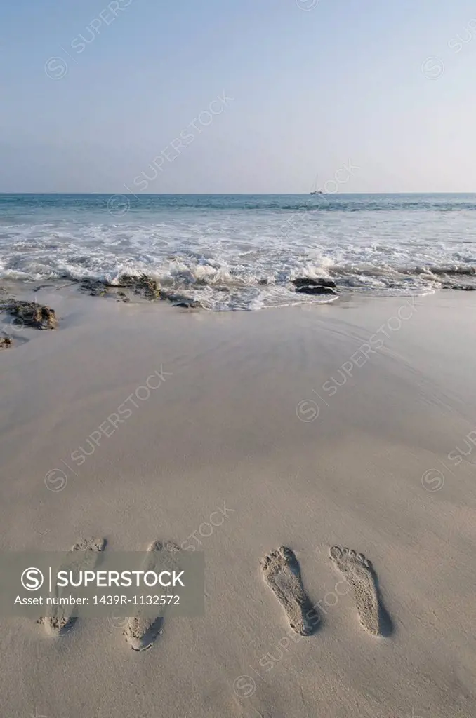 Two people´s footprints on sand