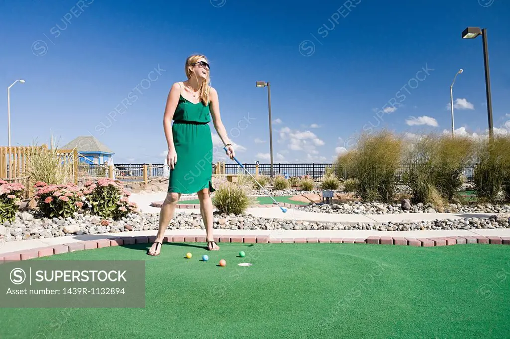 Woman playing miniature golf