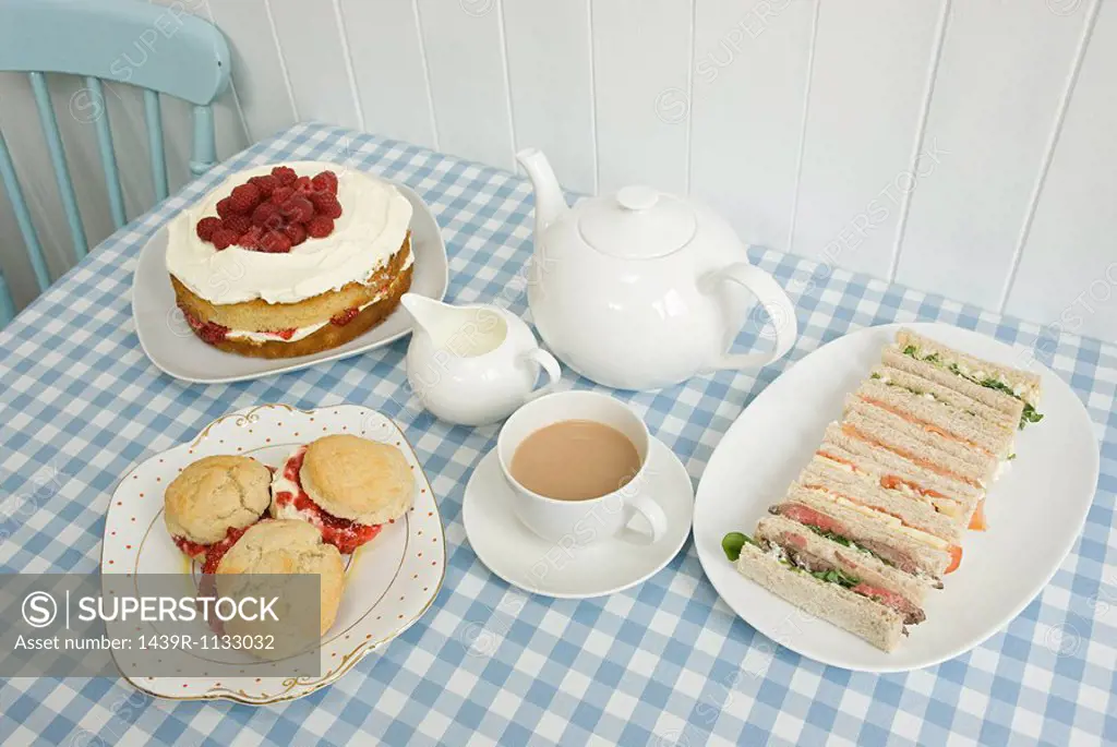Tea with sandwiches and cakes