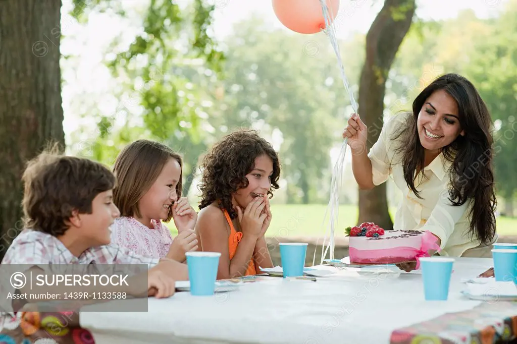 Children at birthday party with birthday cake