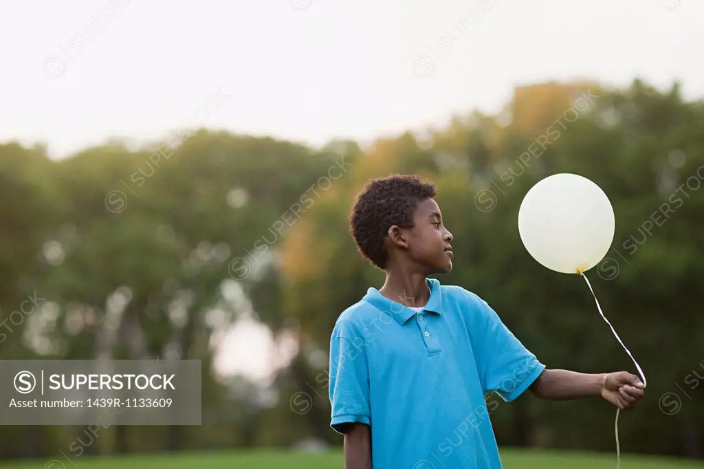 Boy at birthday party holding balloon