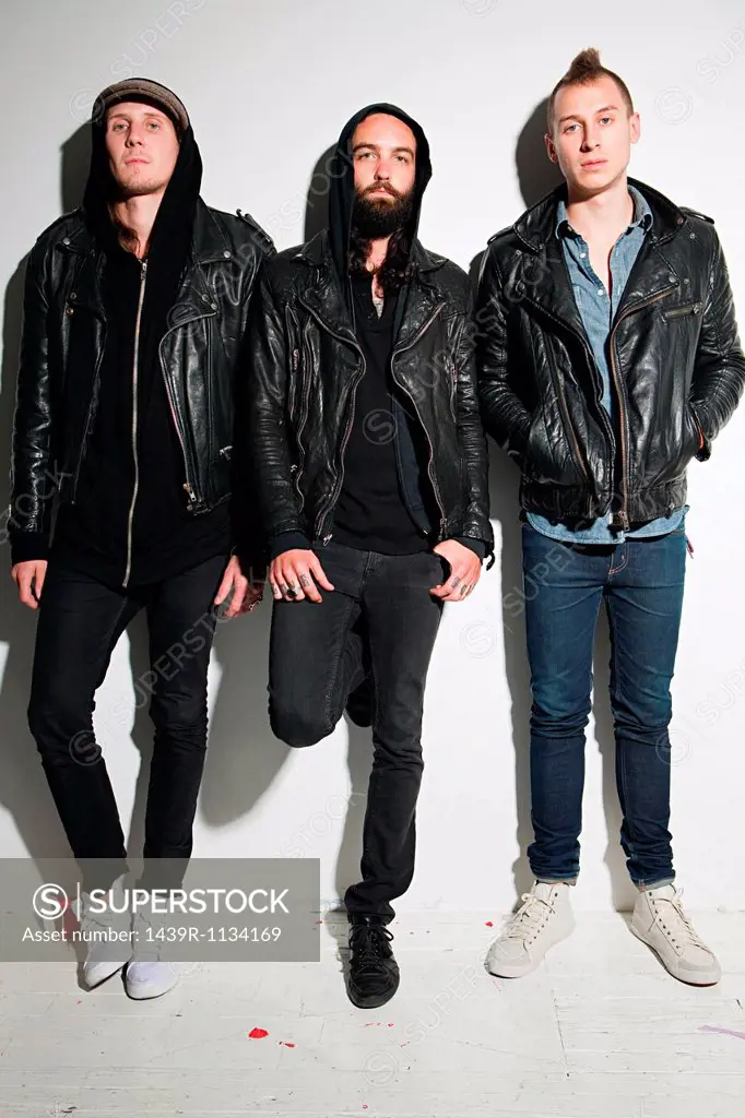 Three men wearing leather jackets at party