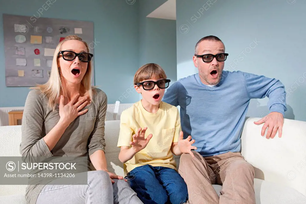 Family watching 3d movie at home