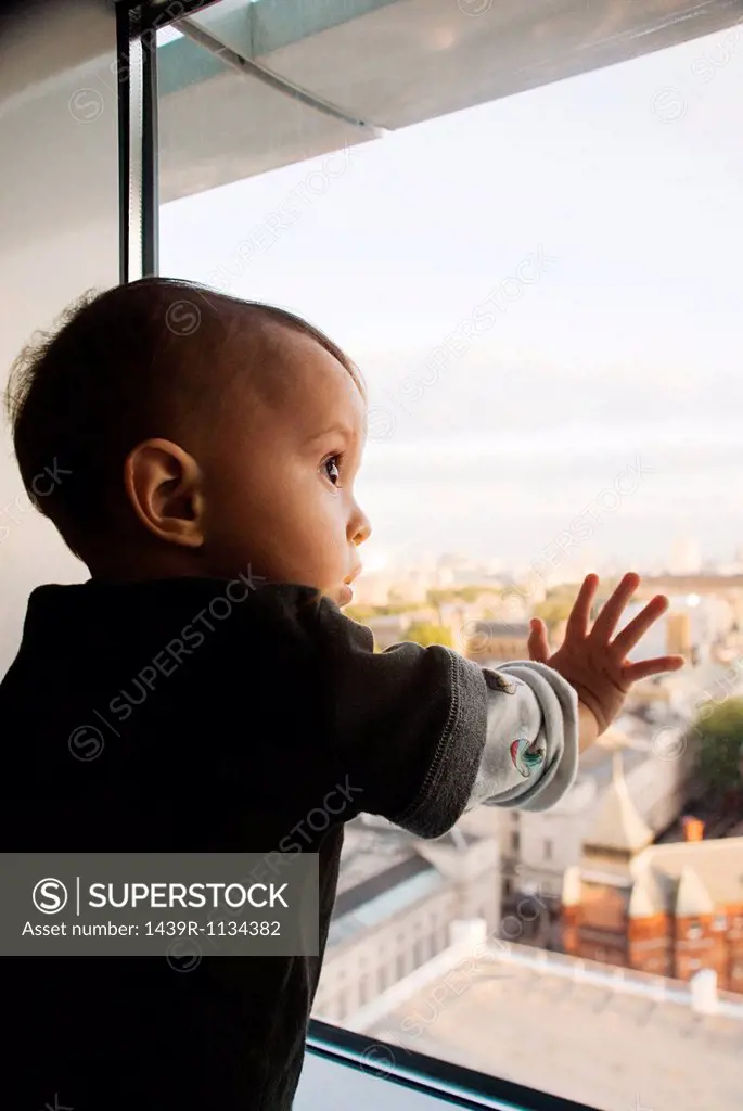 Baby boy touching window