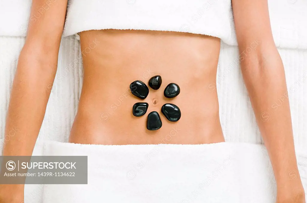 Young woman having hot stone therapy