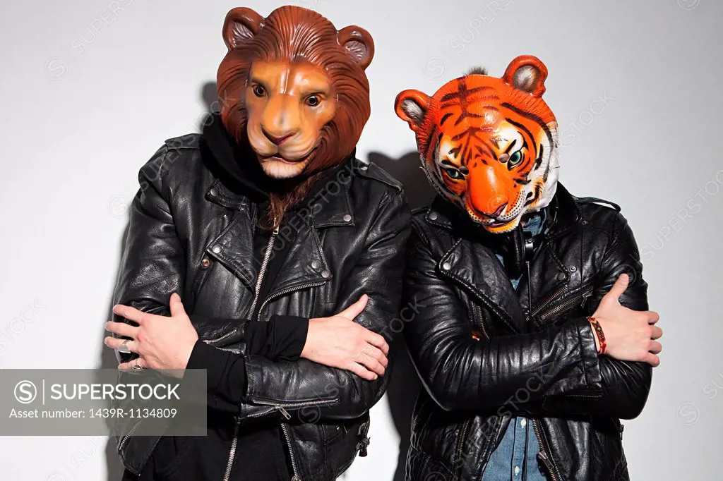 People wearing lion and tiger masks at party