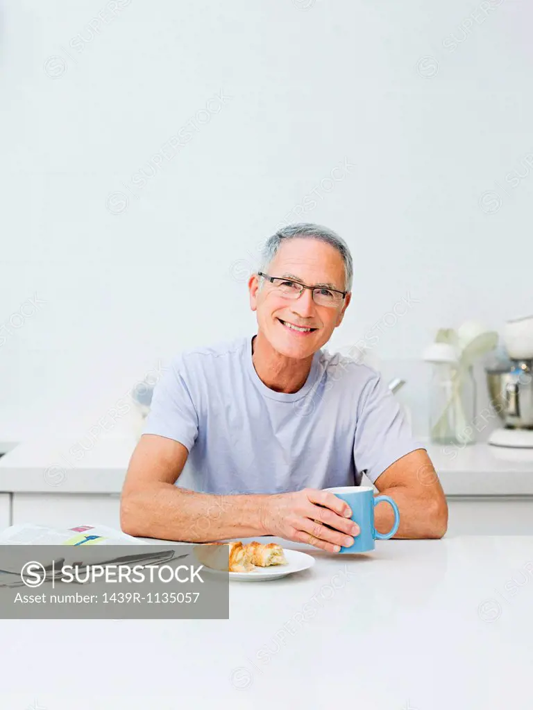 Senior man having breakfast