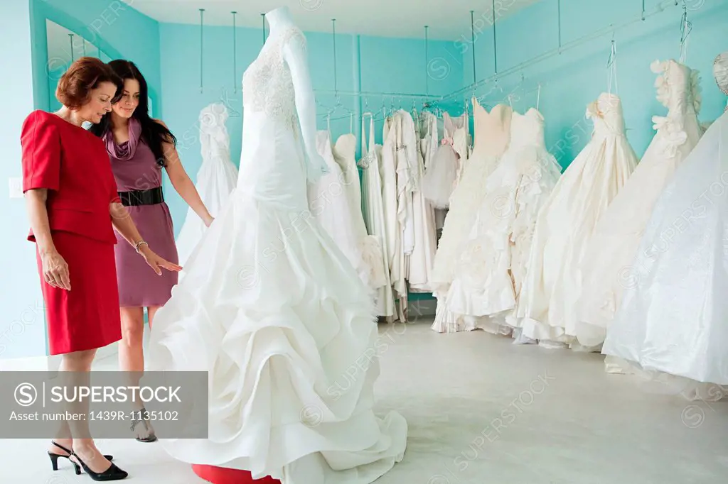 Mother and daughter looking at wedding dresses