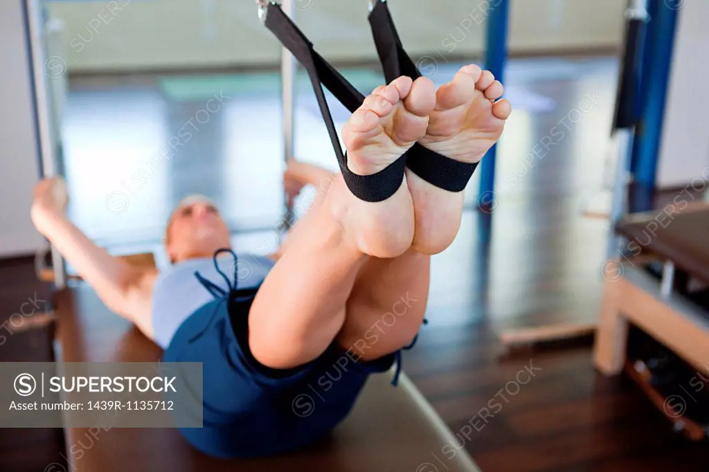Woman doing pilates in gym