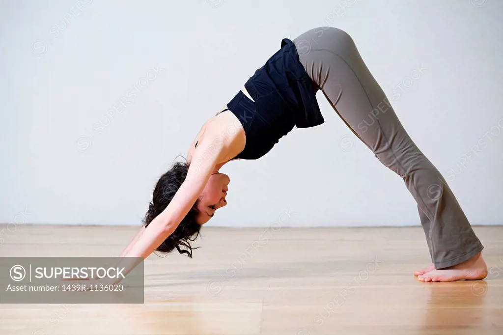 Woman in downward facing dog position during yoga