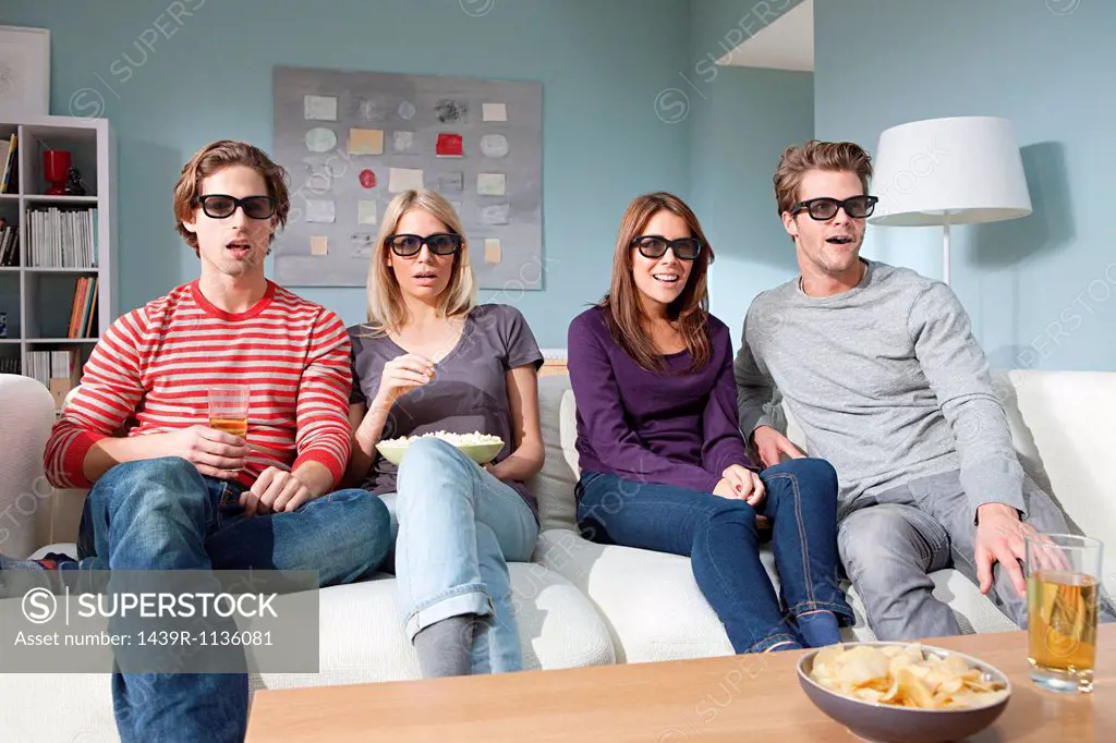 Four friends watching 3d movie at home