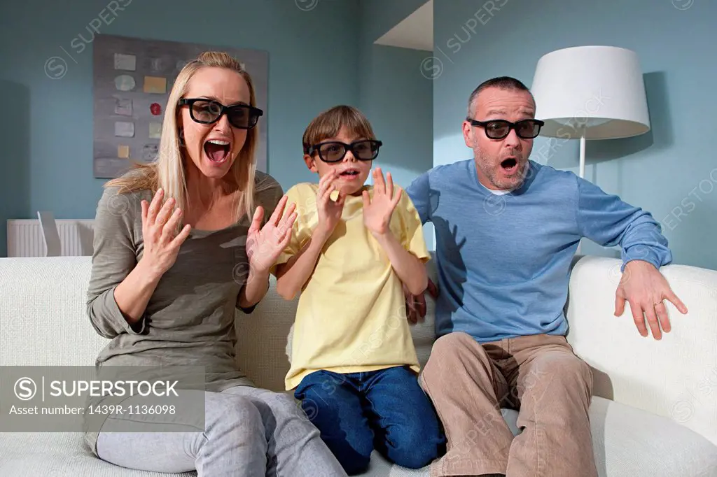 Family watching 3d movie at home