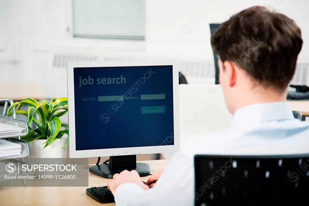 Office worker using computer to perform job search