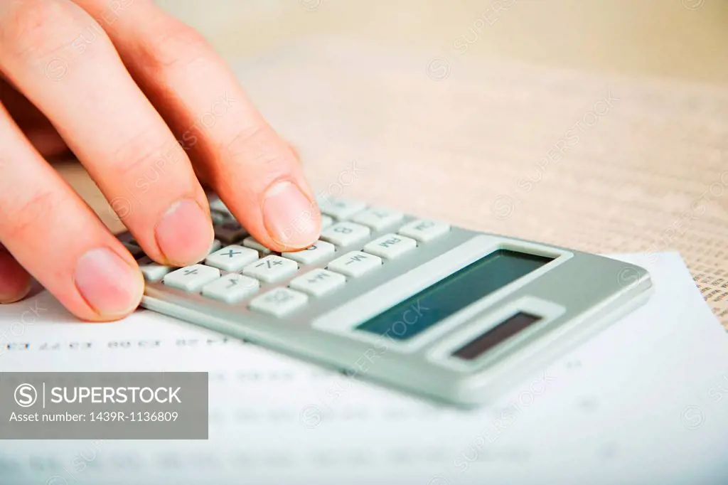 Office worker using calculator