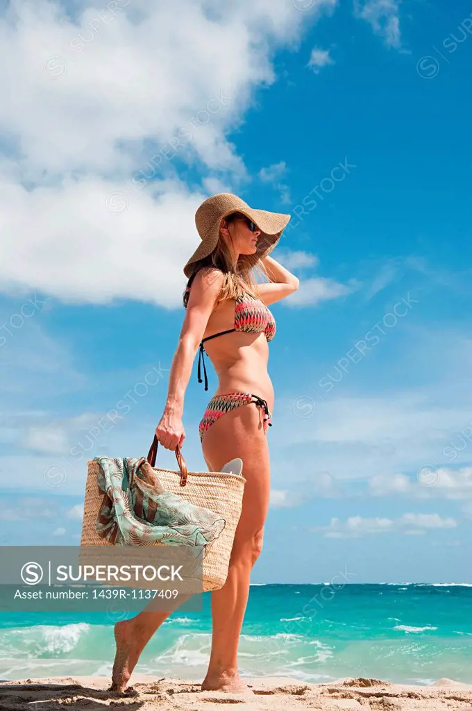 Woman carrying beach bag, Mustique, Grenadine Islands