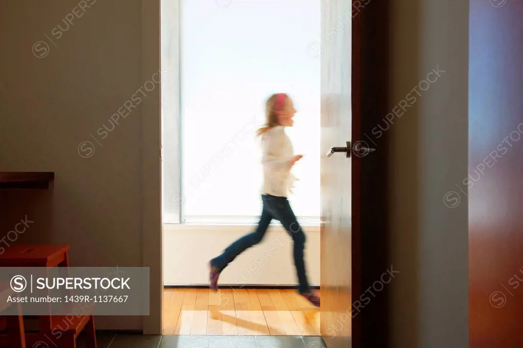 Girl running past doorway