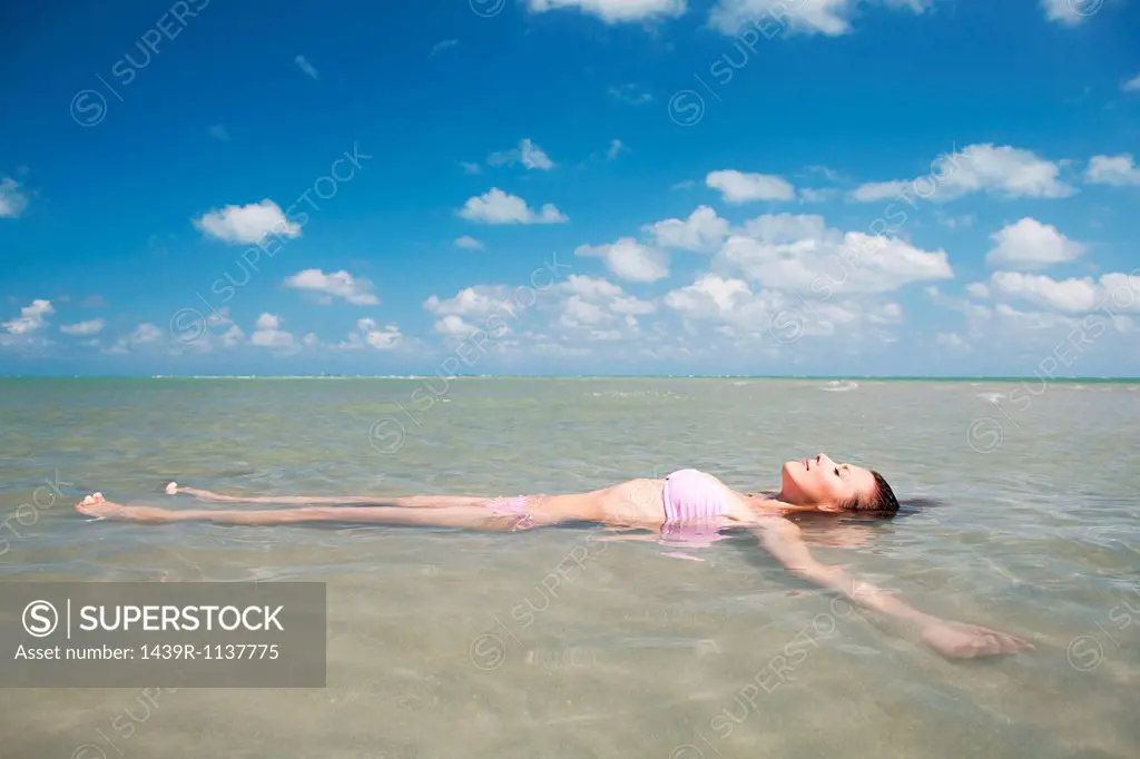 Young woman floating in sea