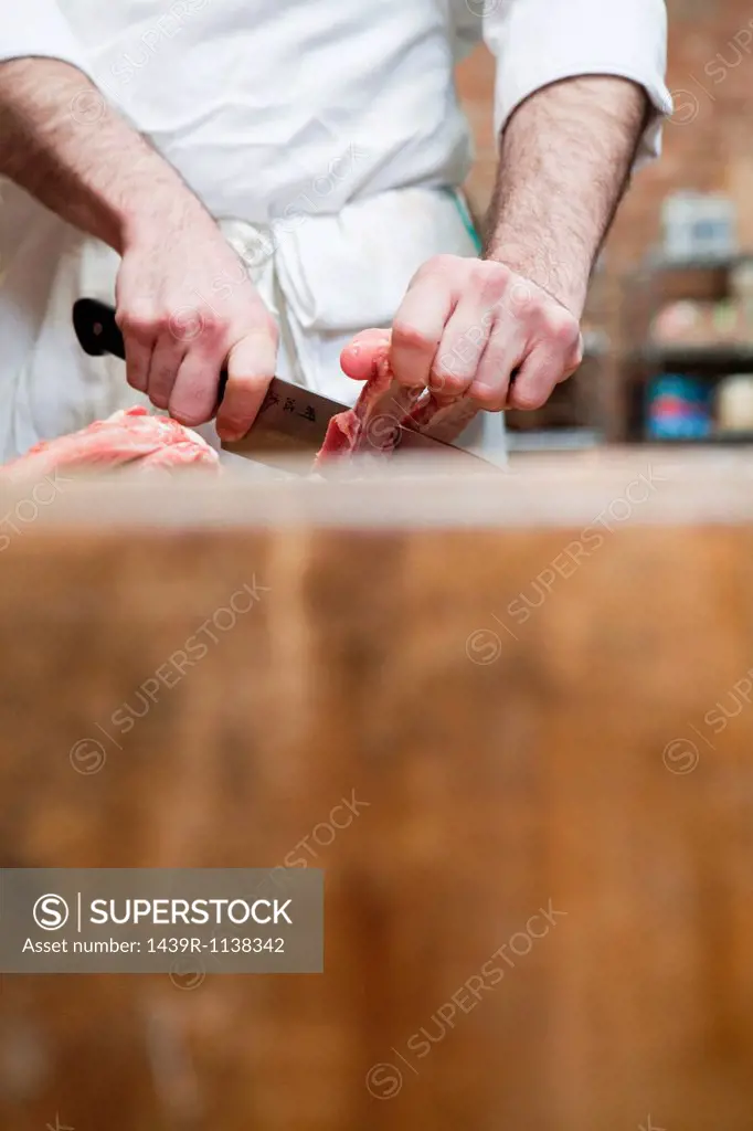 Butcher preparing pork ribs
