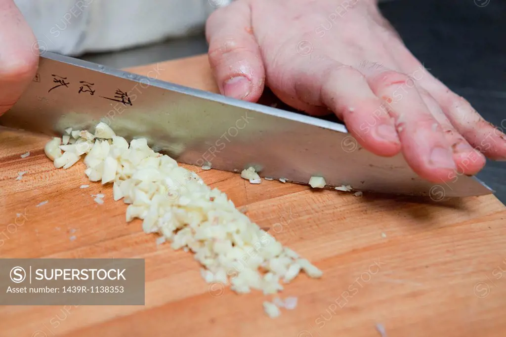 Chef adding dicing onions