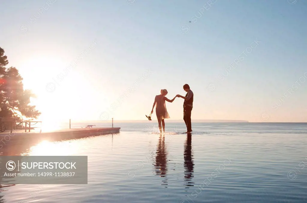 Couple in the ocean at sunset