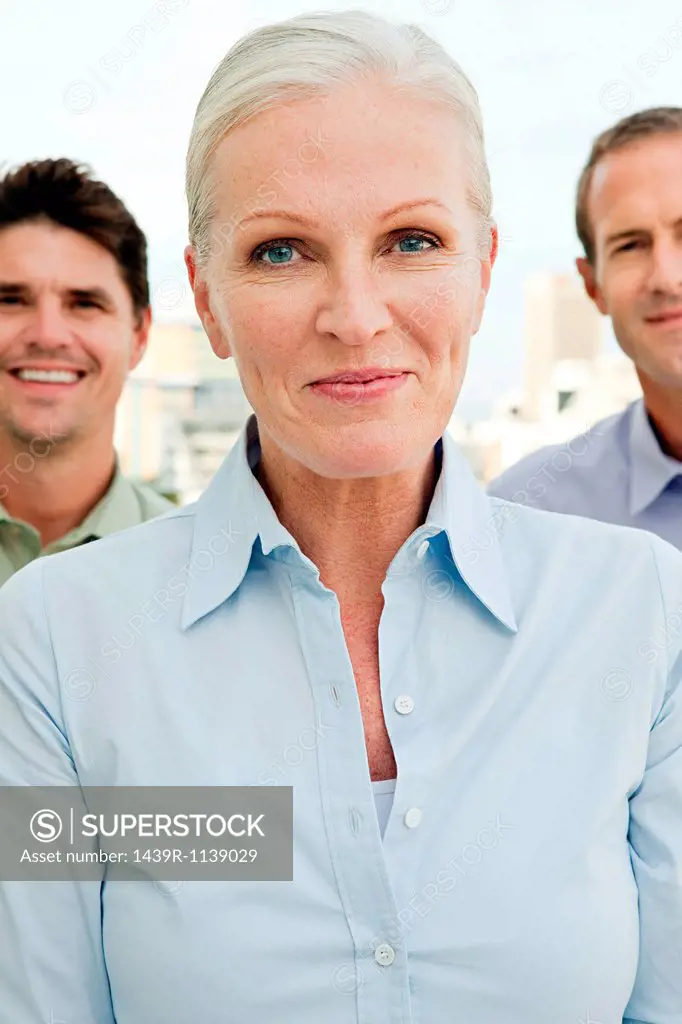 Three businesspeople, focus on woman