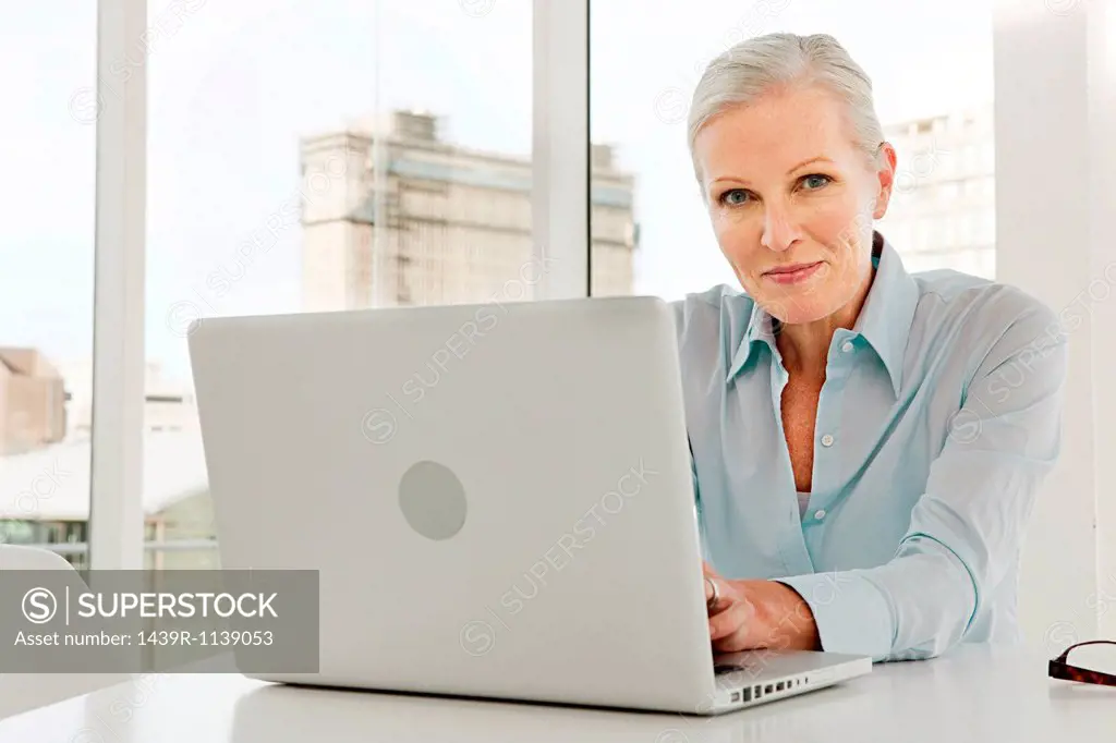 Mature businesswoman using laptop