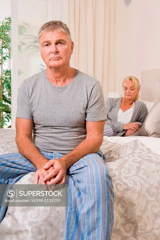 Worried couple in bedroom