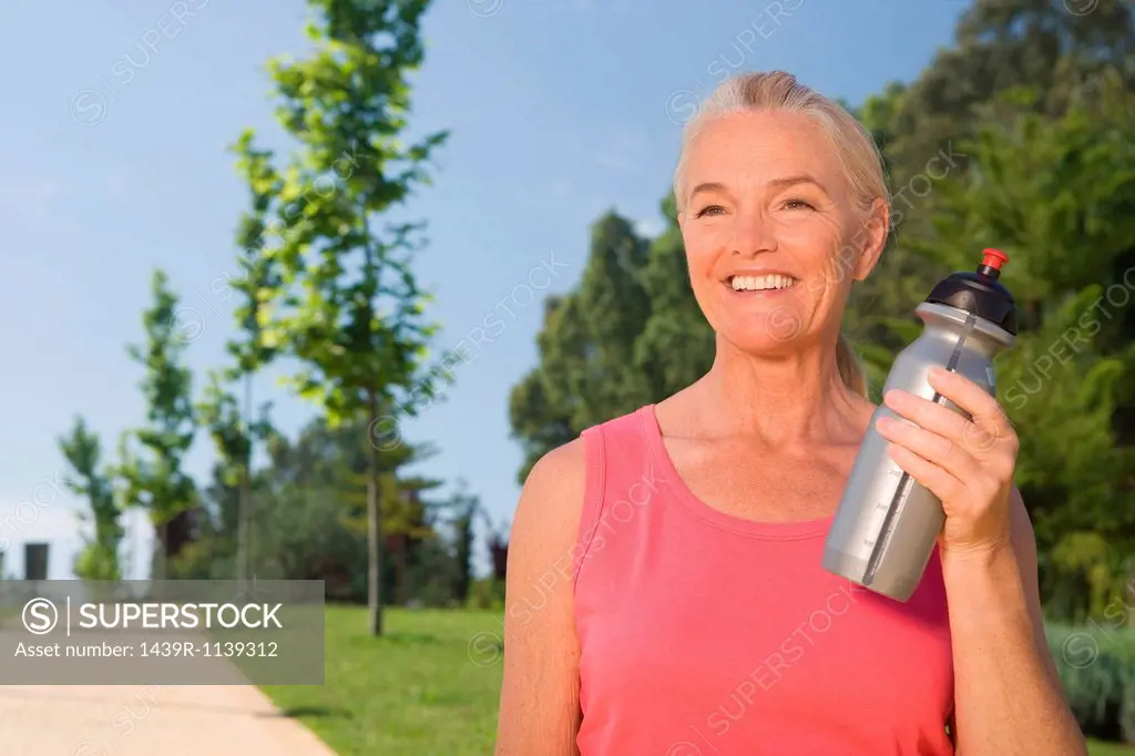 Mature woman runner with water bottle