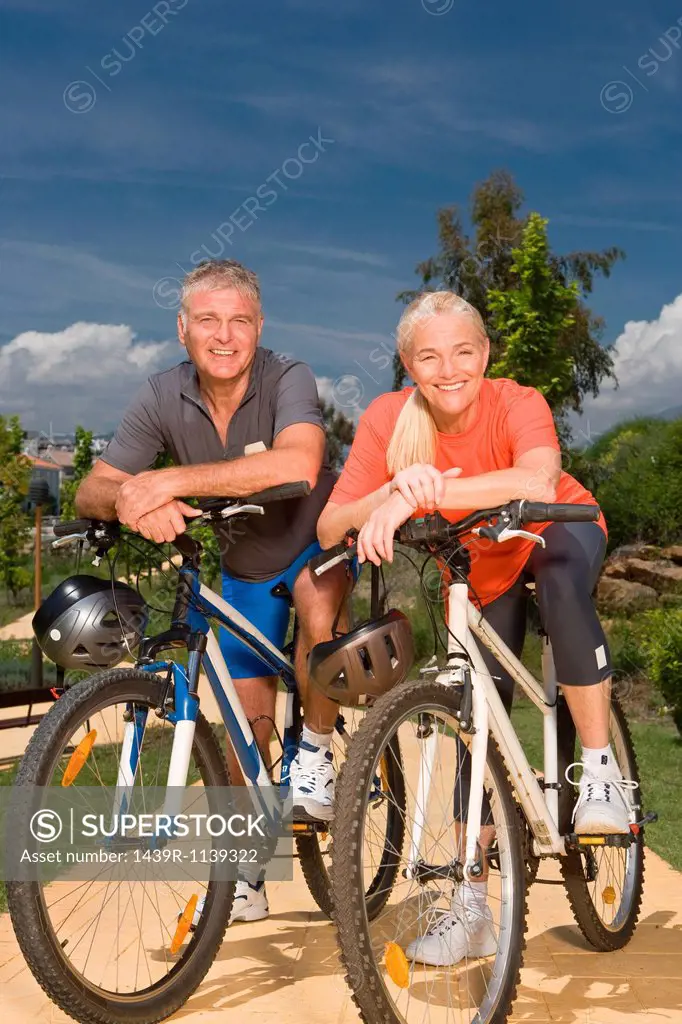 Mature couple on bicycles