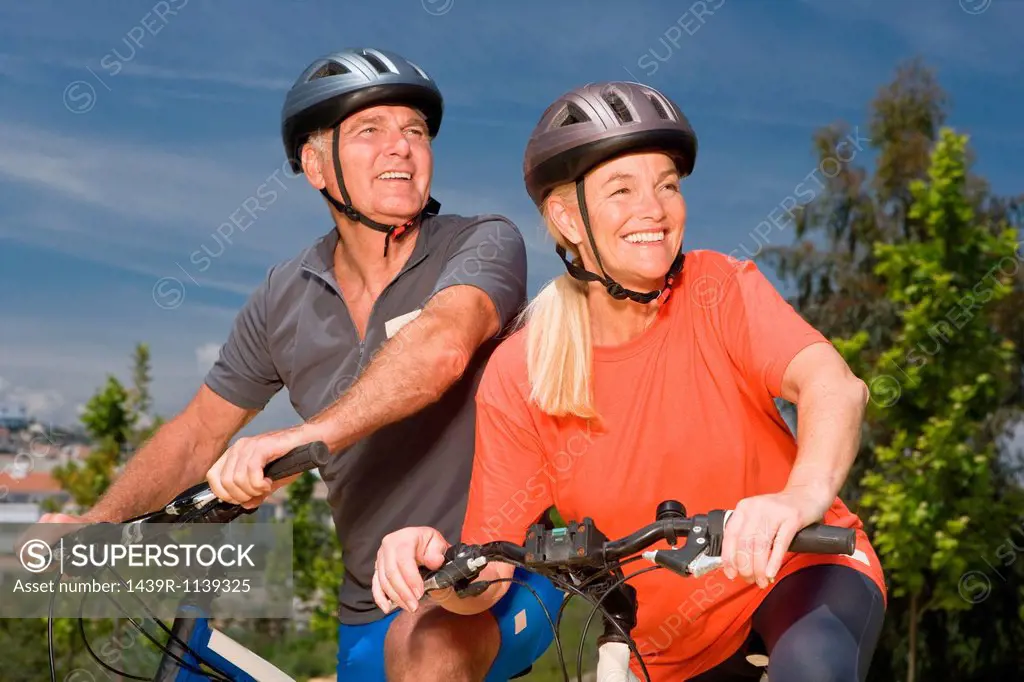 Mature couple on bicycles