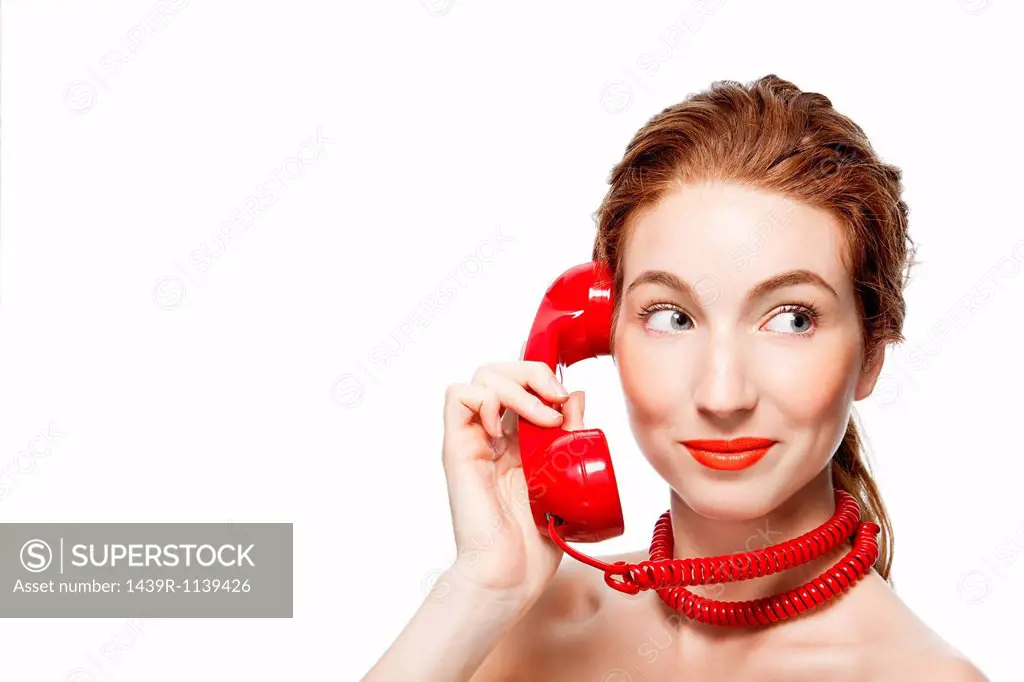 Woman with red telephone cord wrapped around neck