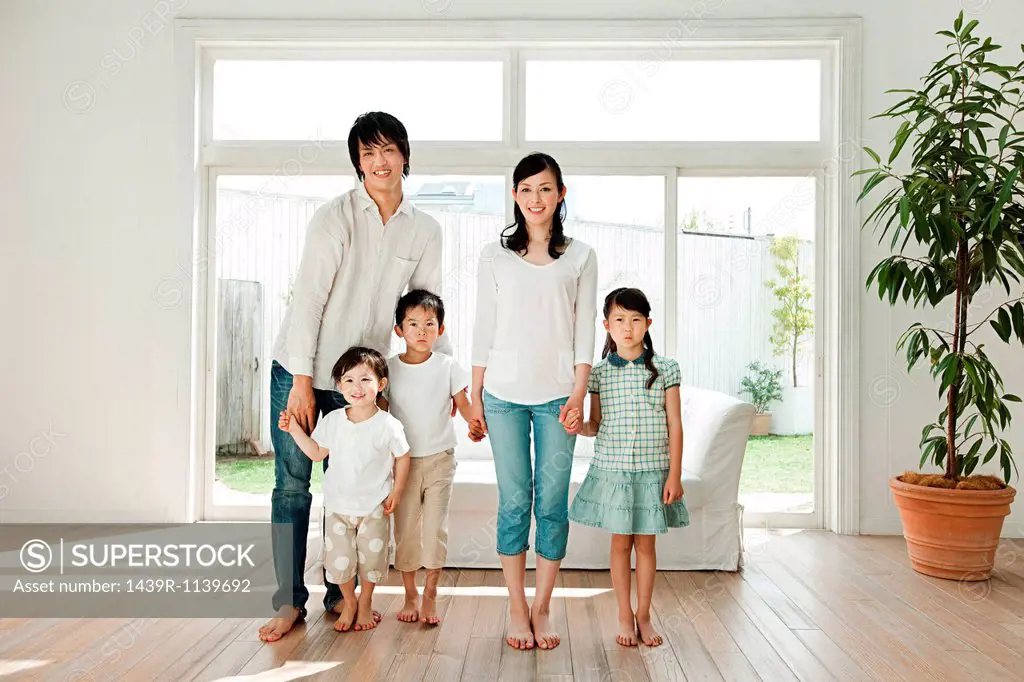 Family with three children at home, portrait