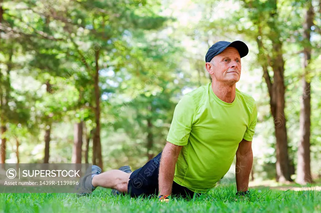 Man stretching on grass
