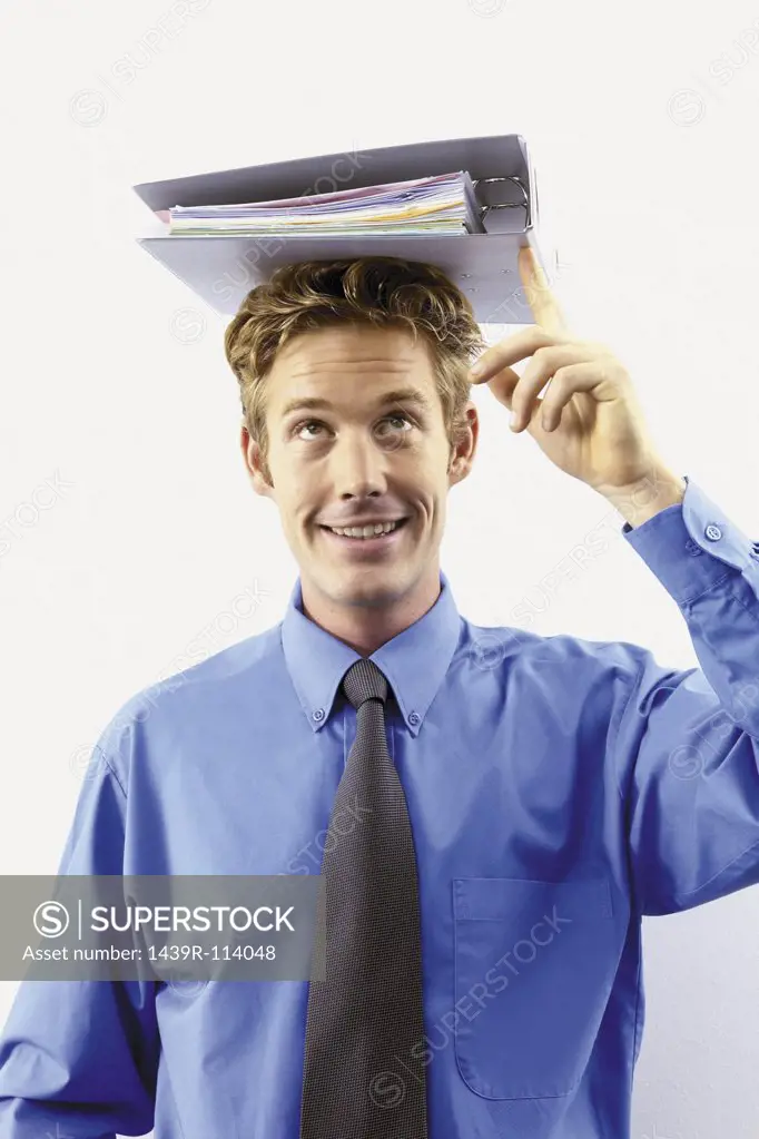 Businessman with file on head