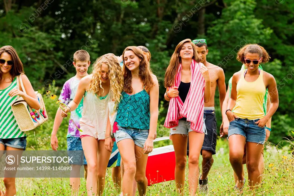 Teenagers going on a picnic together in the countryside
