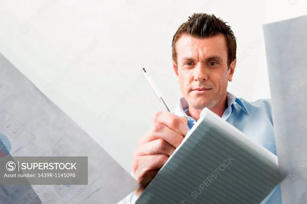Business man writing in a notebook