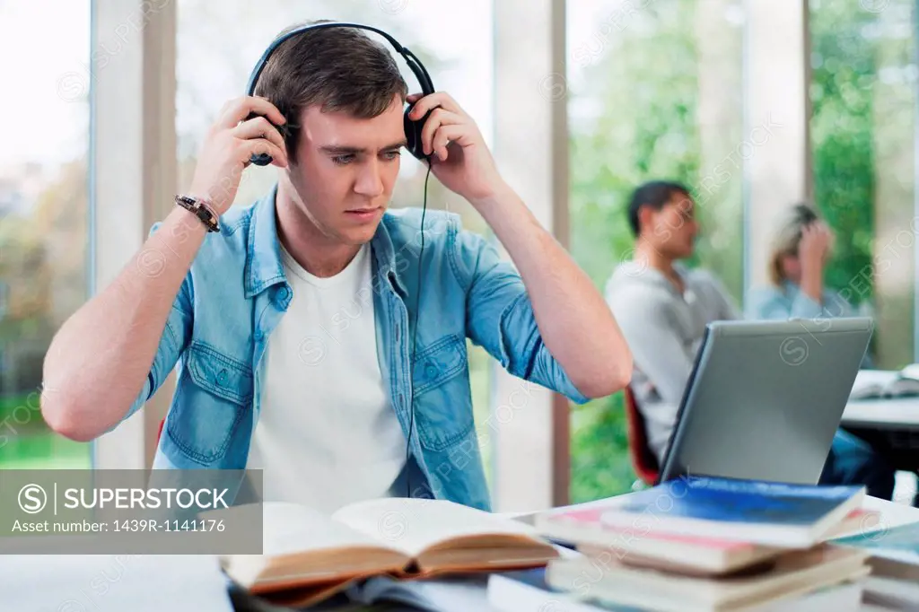 University student putting on headphones