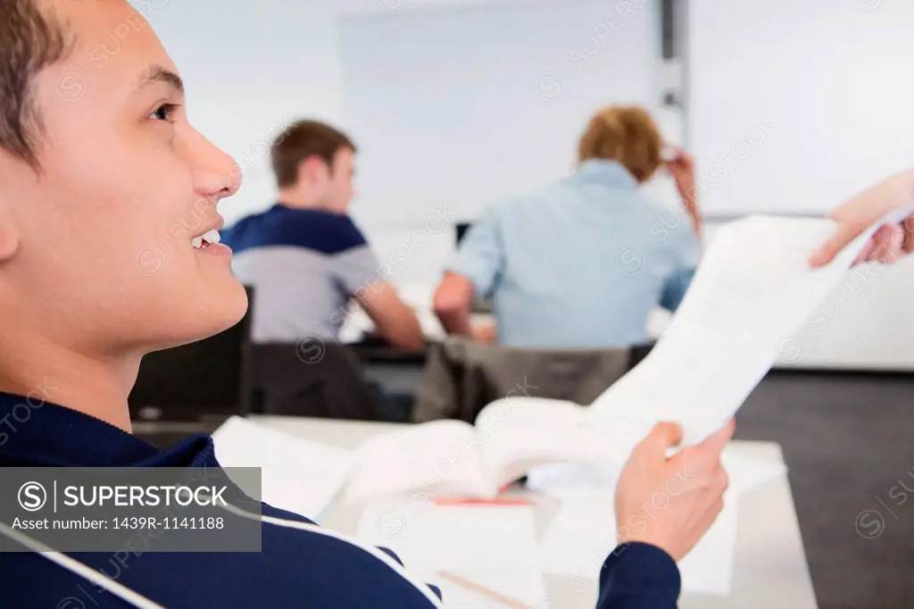 University student receiving exam paper