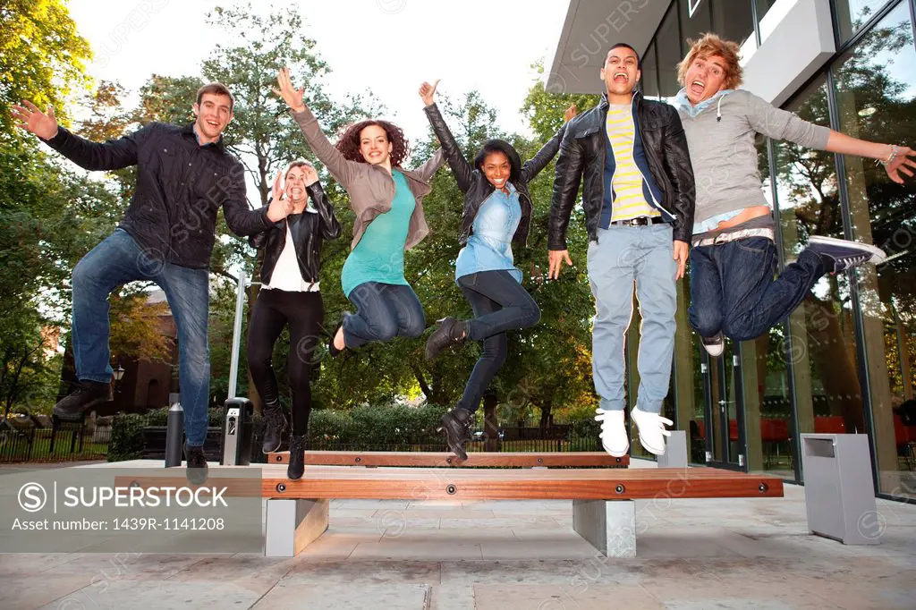 University students jumping at college