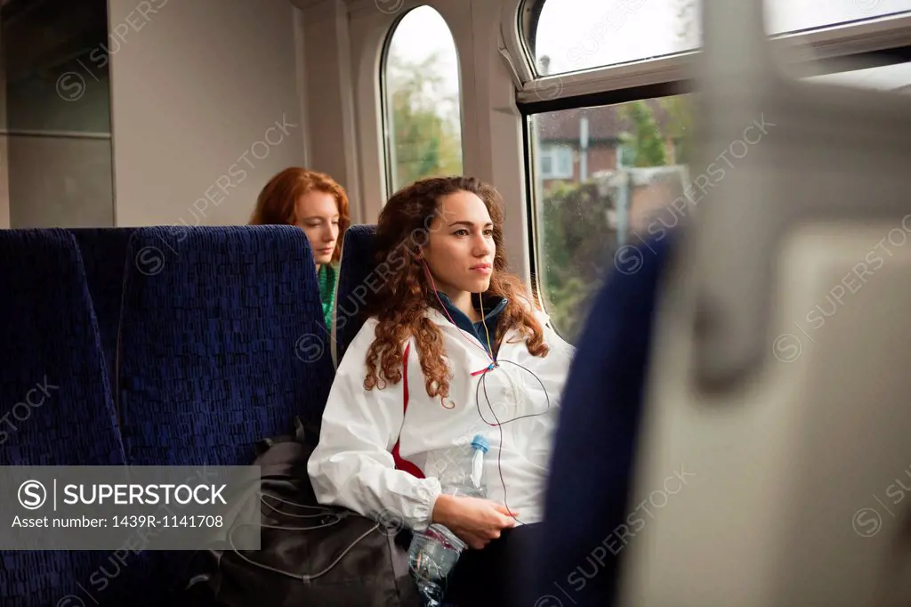 Two young women travelling on train