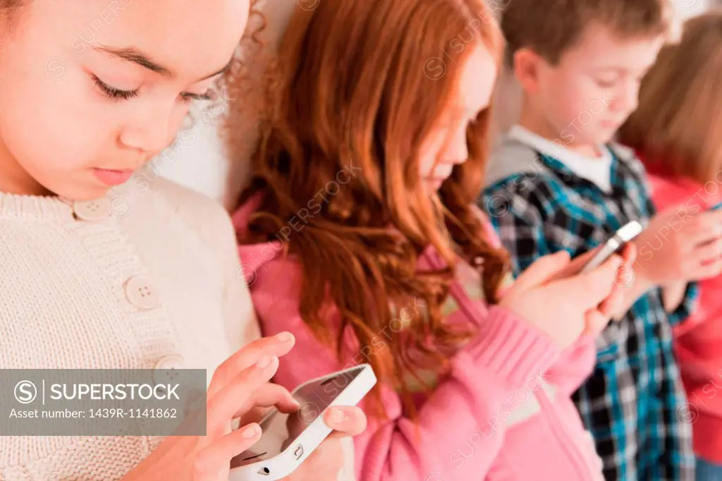 Children looking at smartphones