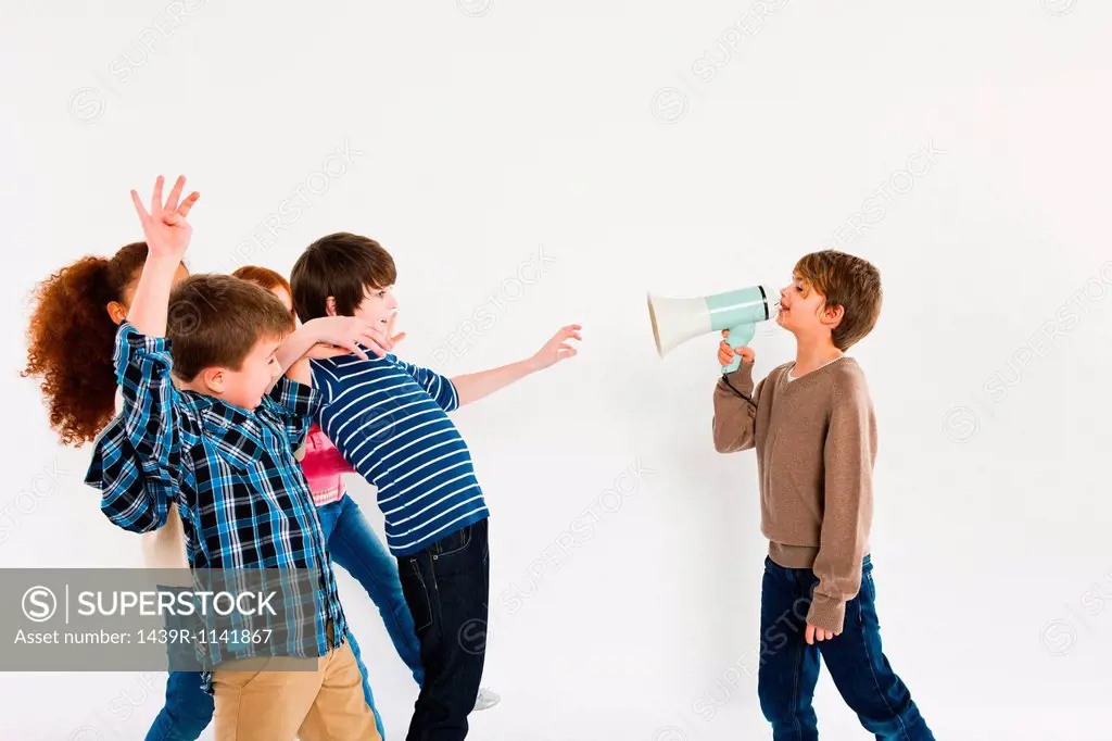Boy with megaphone, shouting at other children